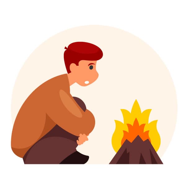 Un ragazzo si sta scaldando vicino al fuoco